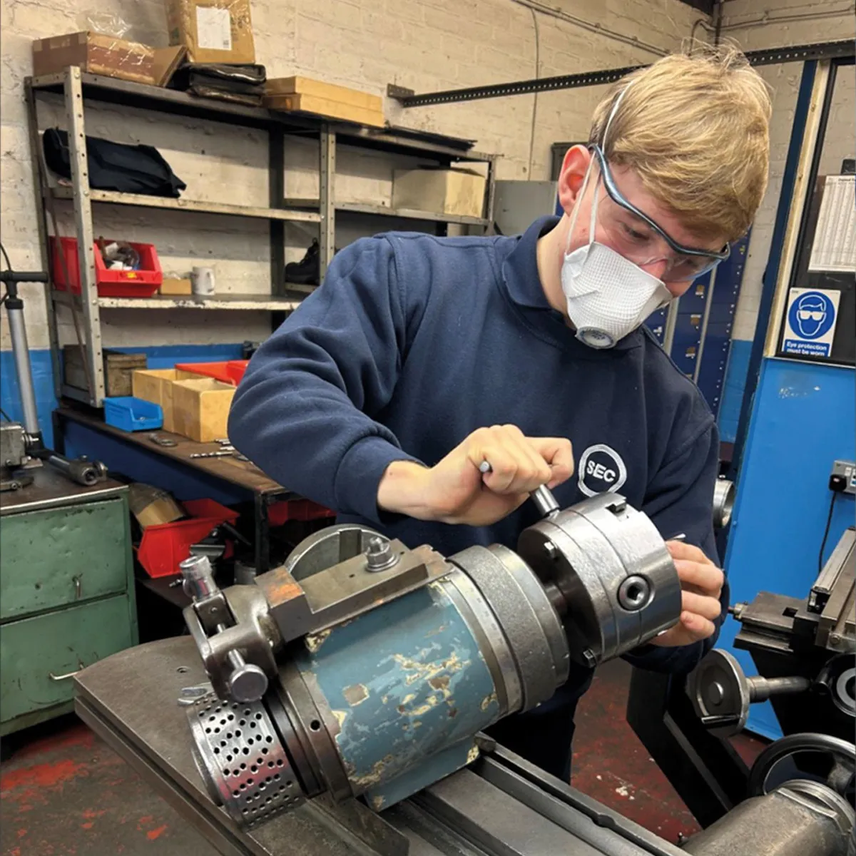 Lewis, apprentice engineer, working at a lathe